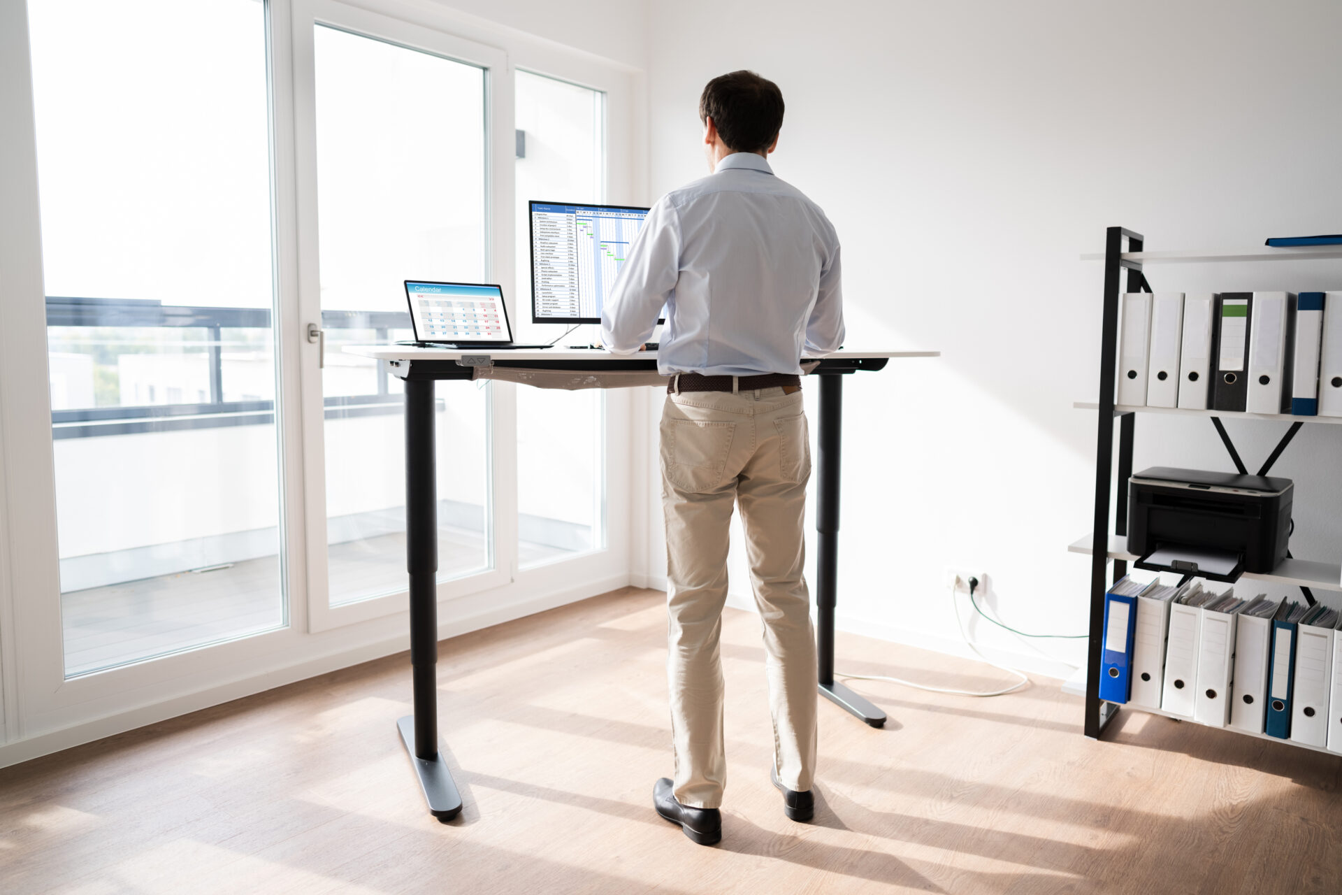 man-working-on-his-computer-at-a-standing-desk